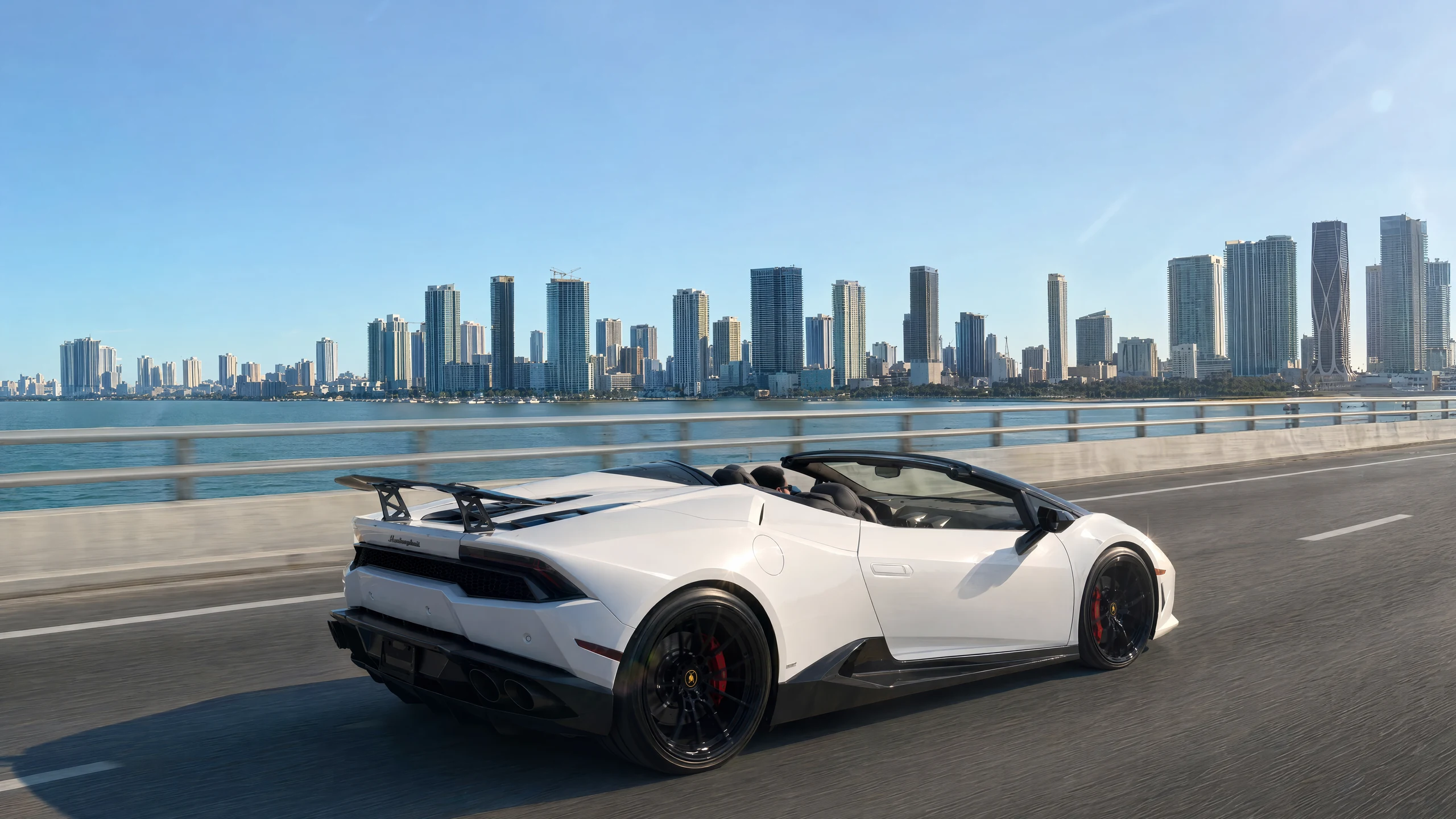 White Lamborghini Huracán Spyder driving along the Miami waterfront